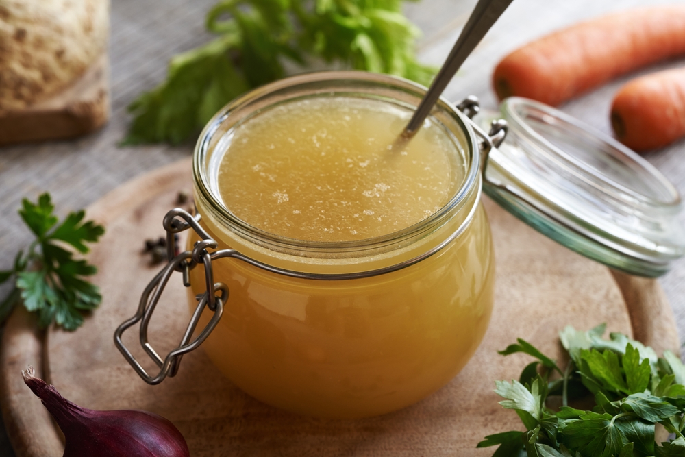 an image showing a jar of homemade chicken bone broth